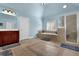 Inviting bathroom with a walk-in shower, soaking tub, and double vanity with storage at 3423 Mulberry Lane Ct, Dacula, GA 30019