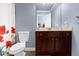 Bathroom with cherry wood vanity, toilet, and shower at 3423 Mulberry Lane Ct, Dacula, GA 30019