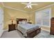 Comfortable bedroom with a large bed, ceiling fan, and natural light from the windows at 3423 Mulberry Lane Ct, Dacula, GA 30019