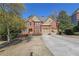 Beautiful two-story brick home with mature landscaping, double garage, and inviting curb appeal at 3423 Mulberry Lane Ct, Dacula, GA 30019