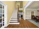 Inviting foyer showcasing hardwood floors, stairs with iron spindles, and access to various rooms at 3423 Mulberry Lane Ct, Dacula, GA 30019