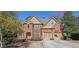 Charming two-story brick home featuring a well-manicured lawn and attached two-car garage at 3423 Mulberry Lane Ct, Dacula, GA 30019