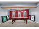 Basement game room features a pool table with red felt, sports memorabilia, neutral walls and carpet at 3423 Mulberry Lane Ct, Dacula, GA 30019