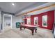 Finished basement game room with pool table, neutral walls and carpet, and three windows for natural light at 3423 Mulberry Lane Ct, Dacula, GA 30019
