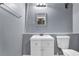 Modern half-bathroom with white vanity and sink, toilet, mirror, and grey walls at 3423 Mulberry Lane Ct, Dacula, GA 30019