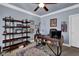 This home office features carpet floors, neutral walls, a ceiling fan, and a large desk with a computer at 3423 Mulberry Lane Ct, Dacula, GA 30019