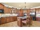Kitchen with wood cabinets, granite countertops, a center island, and modern appliances for cooking at 3423 Mulberry Lane Ct, Dacula, GA 30019
