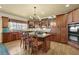 Kitchen with wood cabinets, granite countertops, a center island, and modern appliances for cooking at 3423 Mulberry Lane Ct, Dacula, GA 30019