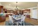 Open-concept kitchen featuring wooden cabinets, stainless steel appliances, and a dining area with natural light at 3423 Mulberry Lane Ct, Dacula, GA 30019