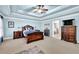 Spacious main bedroom featuring trey ceiling, plush carpeting, and elegant furnishings at 3423 Mulberry Lane Ct, Dacula, GA 30019
