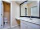 Bright bathroom features a large mirror, vanity, and a separate toilet area at 240 Renaissance Pkwy # 116, Atlanta, GA 30308