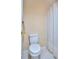Bright bathroom features a standard toilet and shower with a neutral patterned shower curtain at 240 Renaissance Pkwy # 116, Atlanta, GA 30308