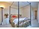 Bedroom features a four poster bed, neutral tones, and decor at 240 Renaissance Pkwy # 116, Atlanta, GA 30308