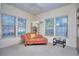 Bright bedroom featuring a chaise lounge, multiple windows, and a vintage aesthetic at 240 Renaissance Pkwy # 116, Atlanta, GA 30308