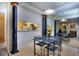 Charming dining area with decorative columns, an open view to the kitchen, and a mirrored wall at 240 Renaissance Pkwy # 116, Atlanta, GA 30308