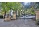 Gated entrance to a residential complex featuring brick pillars and lush greenery at 240 Renaissance Pkwy # 116, Atlanta, GA 30308