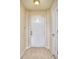 Clean, bright entryway with tile flooring, a white front door, and access to an adjoining room at 240 Renaissance Pkwy # 116, Atlanta, GA 30308