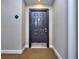 Neutral hallway featuring a solid dark-colored entry door and apartment number at 240 Renaissance Pkwy # 116, Atlanta, GA 30308