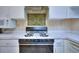 A well-maintained kitchen with white countertops and cabinets and stainless steel appliances at 240 Renaissance Pkwy # 116, Atlanta, GA 30308