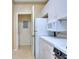 Functional kitchen with white cabinets, modern appliances, and adjacent laundry area at 240 Renaissance Pkwy # 116, Atlanta, GA 30308