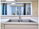 Kitchen features a stainless steel sink with a modern faucet and a bright window view at 240 Renaissance Pkwy # 116, Atlanta, GA 30308