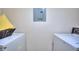 Laundry room includes a washer, dryer, and a decorative basket with a yellow pillow at 240 Renaissance Pkwy # 116, Atlanta, GA 30308