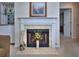 Living room featuring a fireplace, mantel, and bar area, creating a cozy and inviting space at 240 Renaissance Pkwy # 116, Atlanta, GA 30308