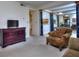 Spacious living room with a fireplace, ample seating, and an adjacent dining area at 240 Renaissance Pkwy # 116, Atlanta, GA 30308