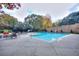 Community pool surrounded by lush trees and patio seating offers a serene atmosphere at 240 Renaissance Pkwy # 116, Atlanta, GA 30308