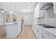 Modern kitchen with white cabinets, quartz countertops and gas cooktop at 1068 Rose Dr, Marietta, GA 30060