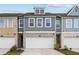 Townhouse exterior with gray siding, brick accents, and a two-car garage at 1068 Rose Dr, Marietta, GA 30060