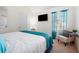 Cozy bedroom with a plush queen bed, TV, and serene natural light at 6476 Snowden Dr, Atlanta, GA 30349