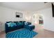 Comfortable living room with plush blue seating and direct access to the dining room at 6476 Snowden Dr, Atlanta, GA 30349