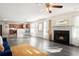 Open-concept living room featuring a fireplace, dining area, and kitchen at 6476 Snowden Dr, Atlanta, GA 30349