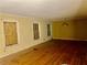 Living room with hardwood floors and boarded windows, needs renovation at 2328 Columbia Dr, Decatur, GA 30032