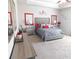 Main bedroom with gray upholstered bed and red accents at 104 Karis Cv, Mcdonough, GA 30252