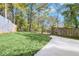 The home has a spacious backyard with a wooden fence and mature trees at 2190 Lang Sw Dr, Atlanta, GA 30315