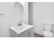 Bathroom features modern vanity, brushed gold faucet and round mirror at 2190 Lang Sw Dr, Atlanta, GA 30315