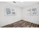 Well-lit bedroom features wood-look flooring, neutral walls, and updated windows at 2190 Lang Sw Dr, Atlanta, GA 30315