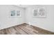 Well-lit bedroom features wood-look flooring, neutral walls, and updated windows at 2190 Lang Sw Dr, Atlanta, GA 30315