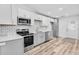 Kitchen features white cabinets, quartz countertops, and stainless steel appliances at 2190 Lang Sw Dr, Atlanta, GA 30315