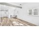 Bright living room with open floor plan, exposed beam, hardwood floors, and natural light at 2190 Lang Sw Dr, Atlanta, GA 30315