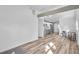 Bright living room with open floor plan, exposed beam, hardwood floors, and view to kitchen at 2190 Lang Sw Dr, Atlanta, GA 30315