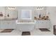 Bright bathroom with dual vanities, soaking tub, and elegant fixtures at 189 Osier Dr, Mcdonough, GA 30252