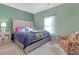 Cozy bedroom with a tufted headboard on the bed, an accent chair, bedside table and neutral-colored carpet at 189 Osier Dr, Mcdonough, GA 30252