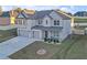 Beautiful two-story brick home with a three car garage, well manicured lawn and landscaping, and a concrete driveway at 189 Osier Dr, Mcdonough, GA 30252