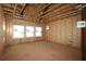 Unfinished room under construction with wood framing and new windows at 4815 Briscoe Dr, Cumming, GA 30028