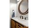 Bathroom features a white quartz countertop, wooden cabinet, bronze fixtures, and decorative mirror at 208 Kenninghall Ln # 627, Smyrna, GA 30082