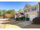 Street view of townhomes featuring manicured front lawns with sidewalks and driveways at 208 Kenninghall Ln # 627, Smyrna, GA 30082