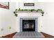 Close up on the fireplace with a decorative mantle, blue tile detail and hardwood floors at 208 Kenninghall Ln # 627, Smyrna, GA 30082